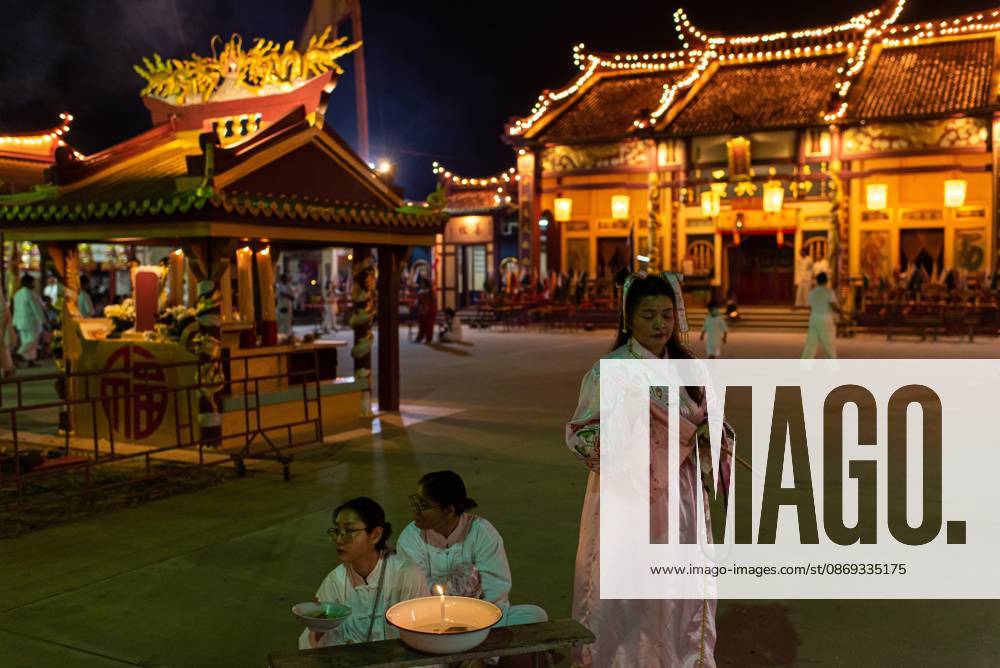Devotees pray at the Chinese shrine during the Vegetarian Festival..The annual Vegetarian Festival is held in Bangkok and many parts of southern Thailand, including Trang, Phatthalung, and Phuket, where worshippers refrain from eating animal products over the nine days, coinciding with the celebration of the Nine Emperor Gods. Trang Thailand - ZUMAs197 20261013_aaa_s197_166