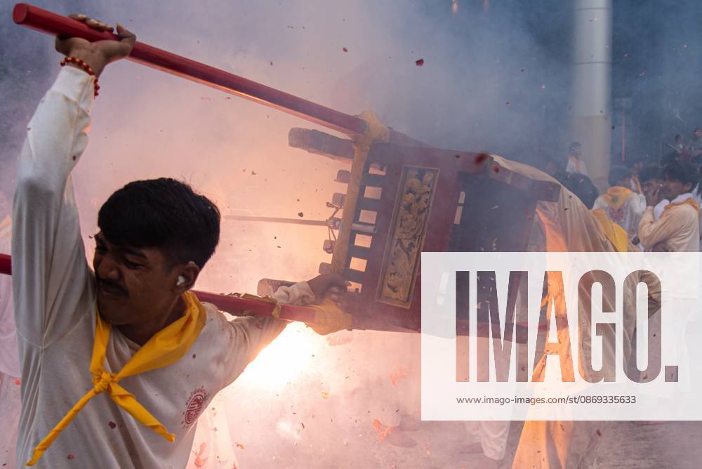Devotees set off firecrackers during a street procession in the Vegetarian Festival..The annual Vegetarian Festival is held in Bangkok and many parts of southern Thailand, including Trang, Phatthalung, and Phuket, where worshippers refrain from eating animal products over the nine days, coinciding with the celebration of the Nine Emperor Gods. Trang Thailand - ZUMAs197 20261013_aaa_s197_189