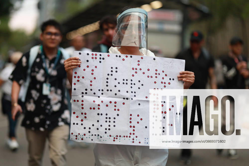Thousands of healthcare workers hold national protest in Mexico City MEXICO CITY, MEXICO - OCTOBER 13: A woman takes part in a national protest march demanding wage increases for healthcare workers and more medical supplies for Mexico s public health system, in Mexico City, Mexico on October 13, 2026. Thousands of members of the Mexican Social Security Institute (IMSS) marched to demand higher wages, improved working conditions, and action to address nationwide shortages of basic medicines and supplies across public hospitals. Daniel Cardenas Anadolu Mexico City Mexico. Editorial use only. Please get in touch for any other usage.