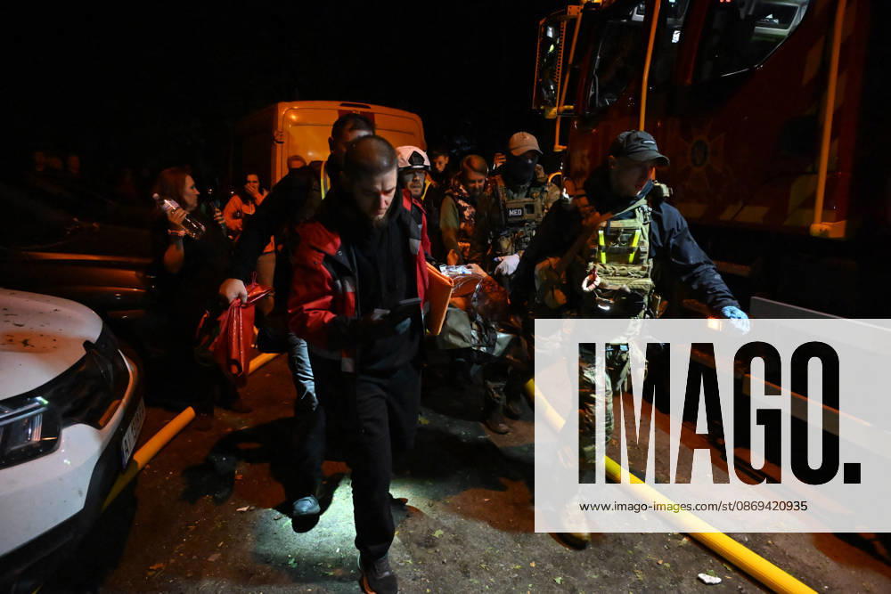 3 Dead and 19 Injured as Russian Missile Hits Residential Building - Kyiv Rescuers carry a person injured in a Russian missile strike on a nine-story residential building in Kyiv? Desnianskyi district, Ukraine, on October 14, 2026. Russia launched a massive ballistic missile attack on the capital. Three women were killed and 19 people were injured in the Desnianskyi district, including a seven-year-old girl. Apartments on the first through eighth floors of the building were also damaged Photo by Oleksandr Klymenko Ukrinform ABACAPRESS.COM Kyiv Ukraine