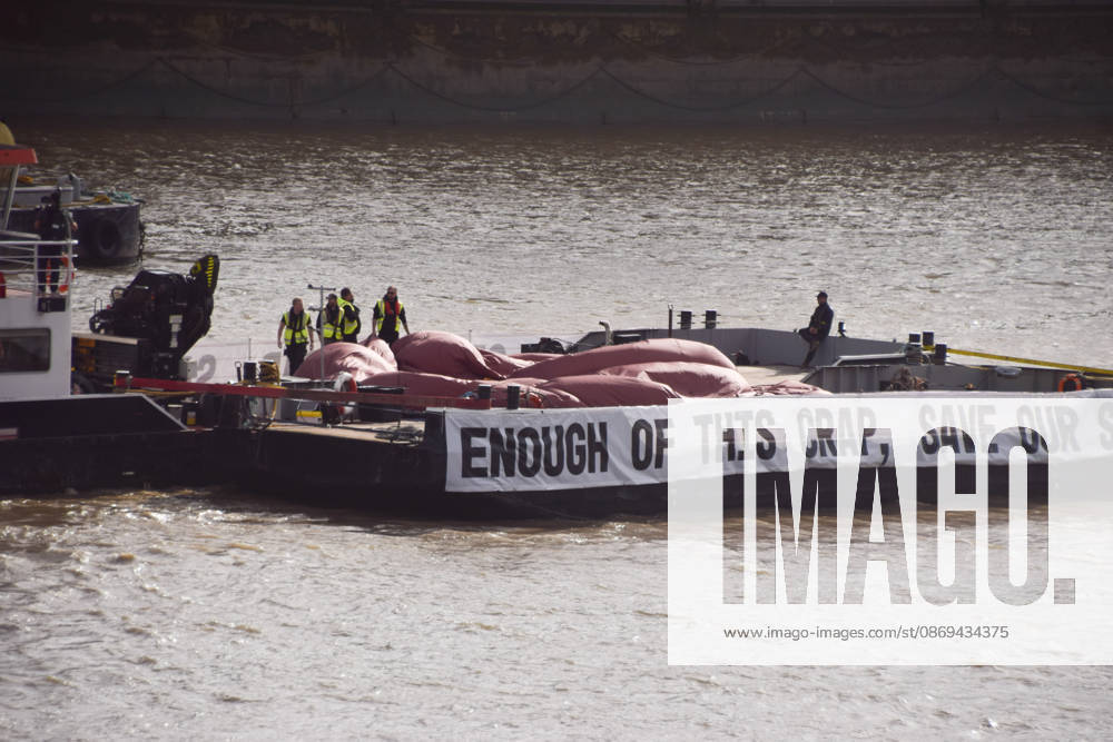 Campaigners prepare to inflate a giant ˜poo on the River Thames outside the Parliament, calling on the UK government to act on sewage pollution. London United Kingdom - ZUMAv130 20261014_zip_v130_017