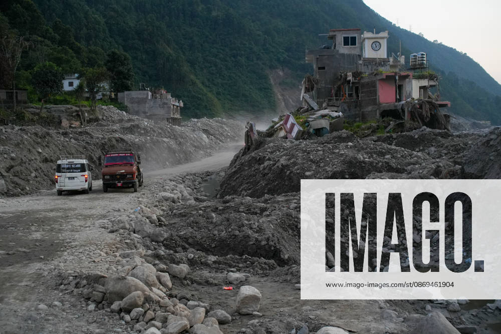 Aftermath of flash floods in Nepal NUWAKOT, NEPAL - OCTOBER 14 : Vehicles pass along a road near houses damaged by devastating flash floods in Betrabati, Nuwakot district, Nepal on October 14, 2026. Road and pedestrian connectivity has been restored with the construction of a new suspension bridge over the Trishuli River, allowing local residents to cross the river after the devastating floods damaged bridges and other infrastructure in the area. Sunil Pradhan Anadolu Nuwakot Nepal. Editorial use only. Please get in touch for any other usage.