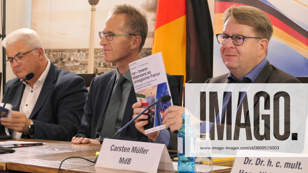 German Member of the Bundestag, Carsten Müller seen holding up the policy paper booklet titled Iran – Innerer Widerstand als strategischer Faktor while seated by MPs ,Axel Knoerig and Detlef Seif. The conference, titled Iran in Crisis: The Democratic Solution and Germany s Responsibility, was organized by the German Solidarity Committee for a Free Iran (DSFI) and the Association of German-Iranians (GDI) at Hopfingerbräu am Brandenburger Tor in Berlin, Germany, on October 14, 2026. The conference brought together German federal lawmakers, former diplomats, and witnesses to discuss human rights, democratic prospects for Iran, and an open letter signed by 80 German dignitaries protesting the Friedrich - ZUMAs197 20261014_aaa_s197_460