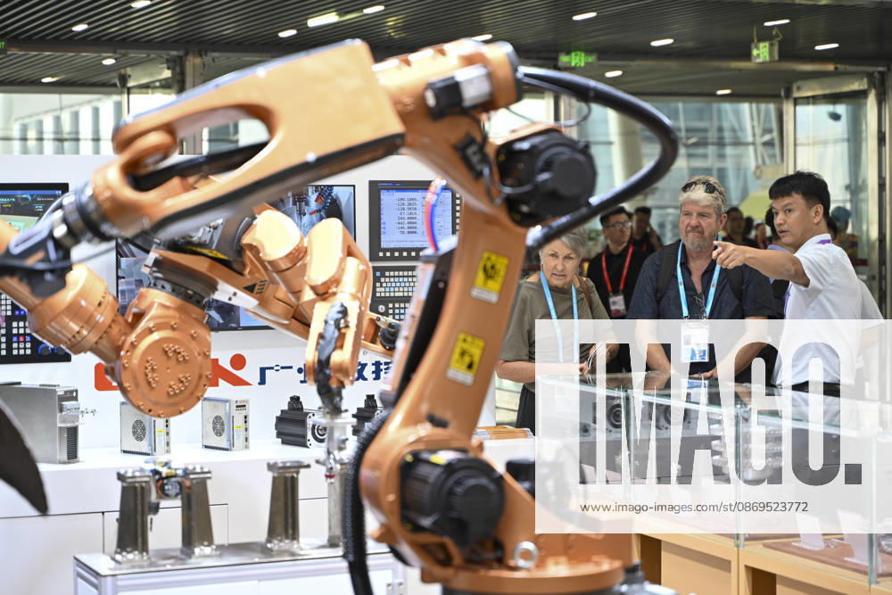 An overseas buyer looks at an industrial robotic arm during the 140th China Import and Export Fair (Canton Fair) on October 15, 2026 in Guangzhou, Guangdong Province of China. The fair runs in three phases until November 4, covering a total exhibition area of 1.55 million square meters.