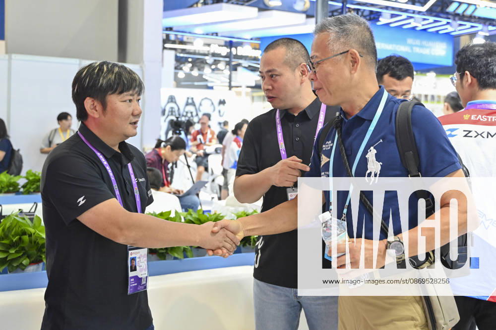 Zhang Xue (L) talks with an overseas buyer at the booth of Chinese motorcycle brand Zhangxue Motorcycle (ZXMOTO) during the 140th China Import and Export Fair (Canton Fair) on October 15, 2026 in Guangzhou, Guangdong Province of China. The fair runs in three phases until November 4, covering a total exhibition area of 1.55 million square meters.