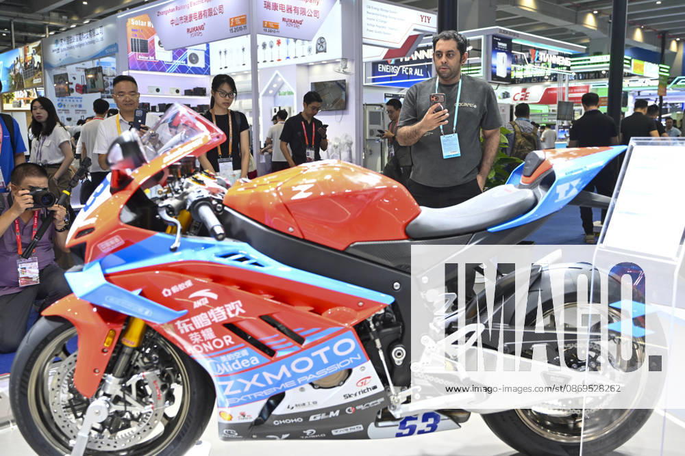 Overseas buyers look at motorcycles displayed by Chinese motorcycle brand Zhangxue Motorcycle (ZXMOTO) during the 140th China Import and Export Fair (Canton Fair) on October 15, 2026 in Guangzhou, Guangdong Province of China. The fair runs in three phases until November 4, covering a total exhibition area of 1.55 million square meters.