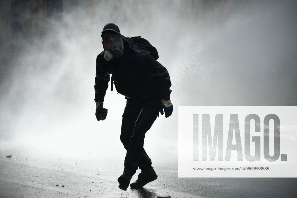 Student protests demanding improved educational conditions continue in Albania TIRANA, ALBANIA - OCTOBER 15: A protester, wearing a gas mask, moves through a cloud of water sprayed by a police water cannon during the third day of demonstrations demanding improved educational conditions in Tirana, Albania, on October 15, 2026. University students are joined by high school students and local residents as tensions escalate, with police using tear gas to disperse demonstrators outside the Ministry of Education and the Parliament building, while protesters throw stones and other objects at police officers. Olsi Shehu Anadolu Tirana Albania. Editorial use only. Please get in touch for any other usage.