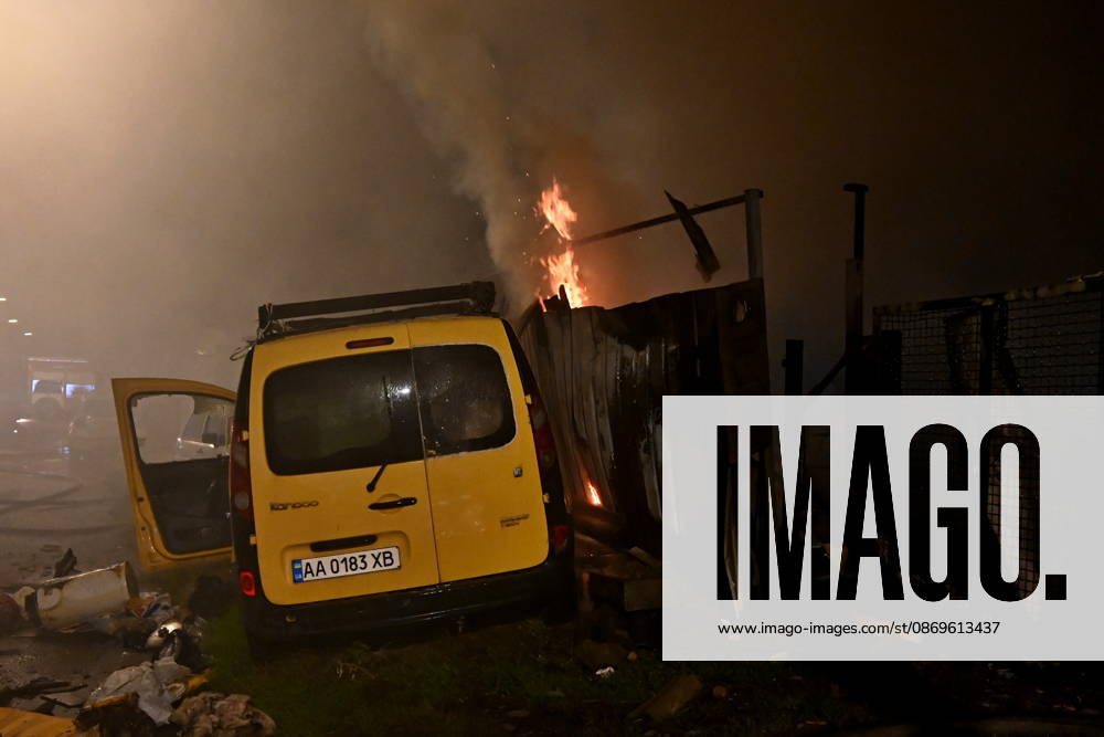 Russian Drone Attack On Kyiv, Ukraine Fire is visible near a damaged car at the scene of a blaze at a private residential house in the Shevchenkivskyi district of Kyiv, Ukraine, on October 15, 2026, following an explosion caused by a jet-powered drone launched by Russia. Kyiv Ukraine