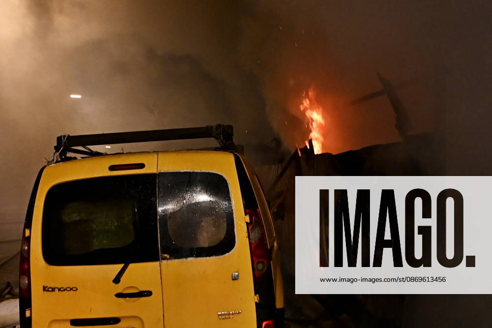Russian Drone Attack On Kyiv, Ukraine Fire is visible near a damaged car at the scene of a blaze at a private residential house in the Shevchenkivskyi district, Kyiv, Ukraine, on October 15, 2026, following an explosion caused by a jet-powered drone launched by Russia. Kyiv Ukraine