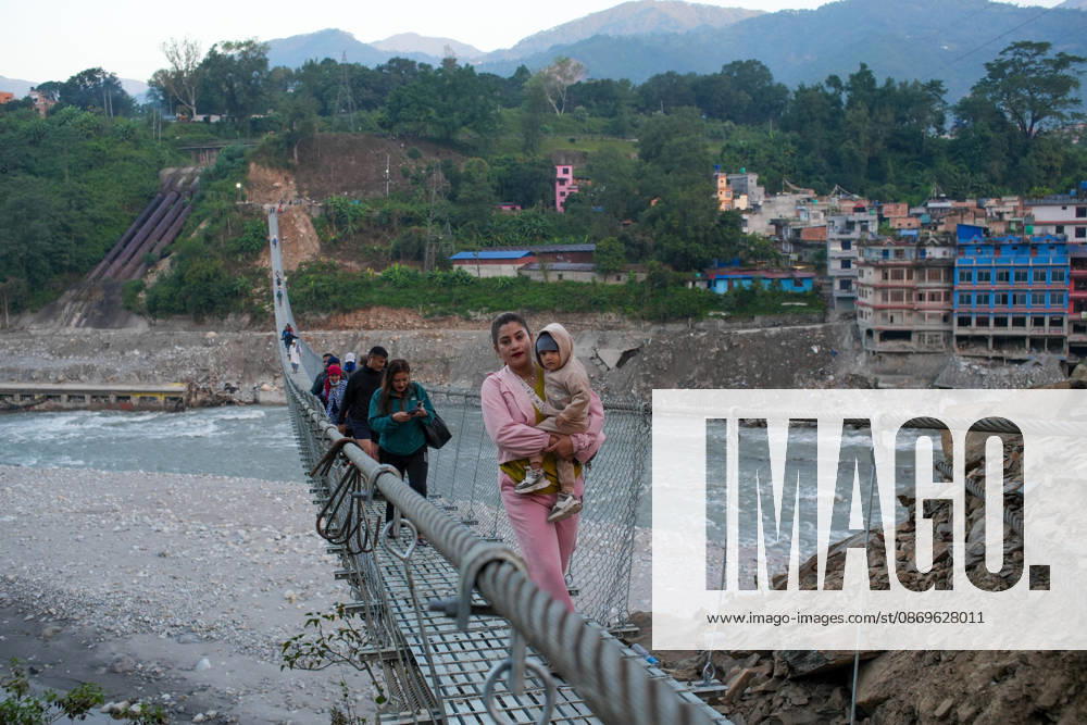 Local residents walk on the newly installed Bailey bridge connecting the border areas of Nuwakot and Rasuwa districts on October 15, 2026 in Nuwakot, Nepal. The bridge was installed to restore road connectivity after severe flooding destroyed existing bridges on August 26, 2026.