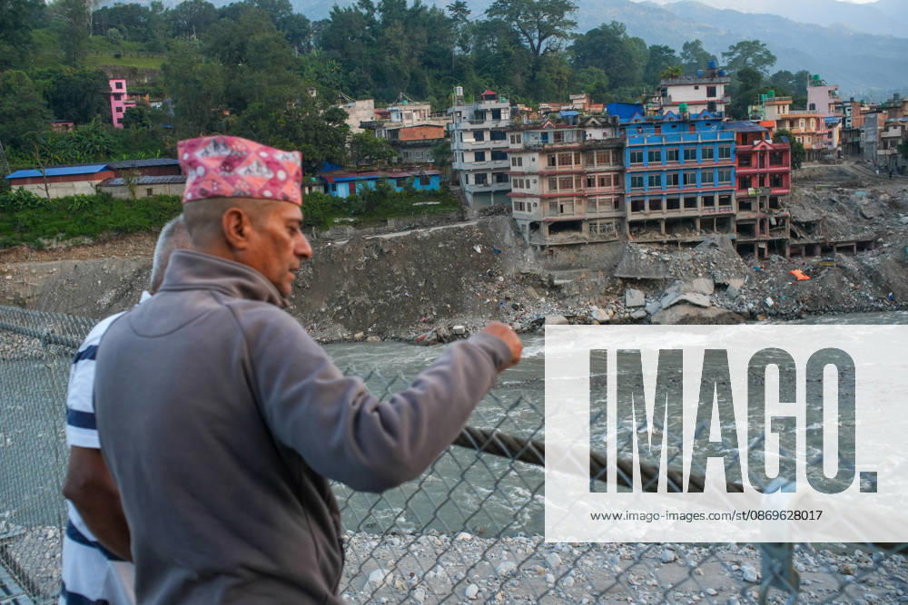 Local residents look out from the newly installed Bailey bridge connecting the border areas of Nuwakot and Rasuwa districts on October 15, 2026 in Nuwakot, Nepal. The bridge was installed to restore road connectivity after severe flooding destroyed existing bridges on August 26, 2026.