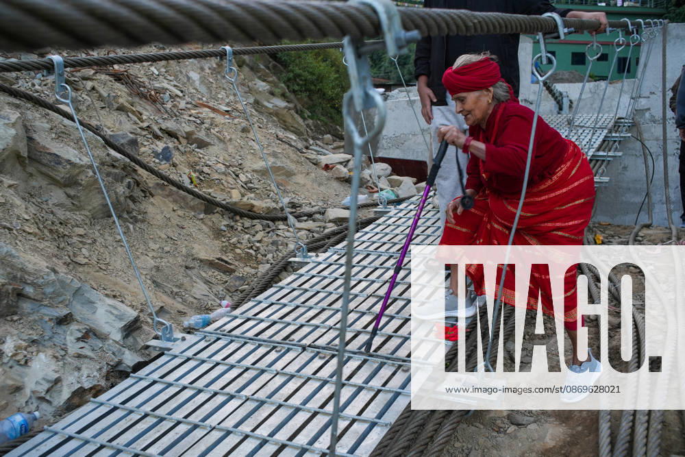 Local residents walk on the newly installed Bailey bridge connecting the border areas of Nuwakot and Rasuwa districts on October 15, 2026 in Nuwakot, Nepal. The bridge was installed to restore road connectivity after severe flooding destroyed existing bridges on August 26, 2026.