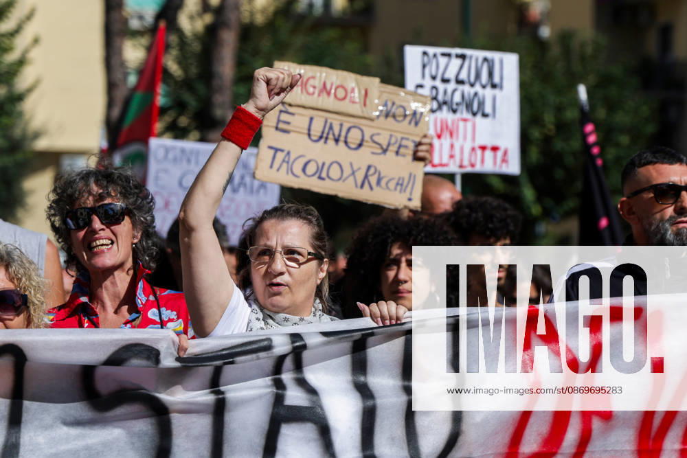 IPA89763001 - NAPLES, ITALY — OCTOBER 16, 2026: Environmental activists, students, and unemployed people take to the streets in the Bagnoli district of Naples to protest the municipal administration’s handling of the environmental remediation of the former Italsider steelworks site. The demonstration focuses on the ongoing redevelopment work in the area, where facilities for the 38th Louis Vuitton America’s Cup—scheduled to take place in Naples in 2027—are being built. Protesters raise concerns about environmental protection, the remediation process, and the project’s impact on the local community.