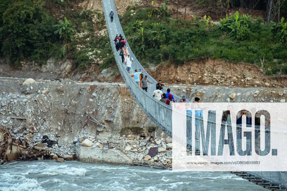 New Bridge Restores Nuwakot Crossing NUWAKOT, NEPAL, OCTOBER 15, 2026: People cross a newly built suspension bridge over the Trishuli River in Bidur Municipality, Nuwakot District. The footbridge restores access between communities after flooding along the Bhotekoshi Trishuli river corridor swept away road bridges and disrupted local transport. NUWAKOT bagmati Nepal