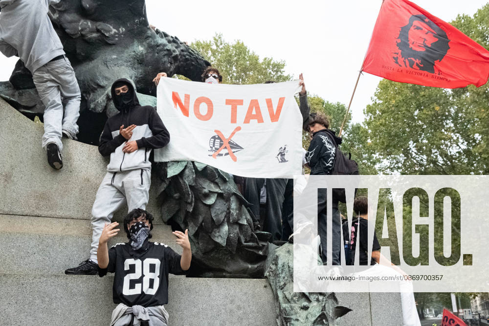 IPA89764420 - Some students standing by the statue on Corso Vittorio Emanuele II, holding flags during a student strike in Turin; Report from Turin, Italy