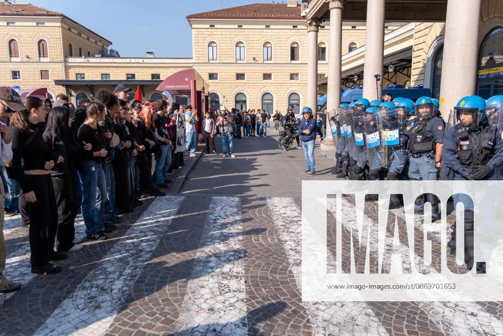 IPA89764840 - Riot squad police officers guarding Bologna s Central Station while students stand in front of them. Bologna, Italy