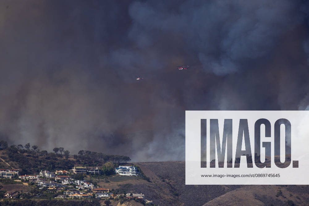 October16, 2026, San Juan Capistrano, California, USA: Fire crews are aggressively battling a wind-driven brush fire that burned several homes and threatened thousands of others in the area of San Juan Capistrano and San Clemente Friday, prompting evacuation orders. The Norte Fire exploded to 465 acres and remains 0 percent contained as of 4 p.m. O.C. Fire Authority officials said the Norte Fire started around 11:30 a.m. near Portico Del Norte and Eminencia Del Norte in San Clemente, east of Interstate 5. Fueled by strong Santa Ana winds, the wildfire then blew into neighboring San Juan Capistrano. San Juan Capistrano USA - ZUMAr19_ 20261016_new_r19_157