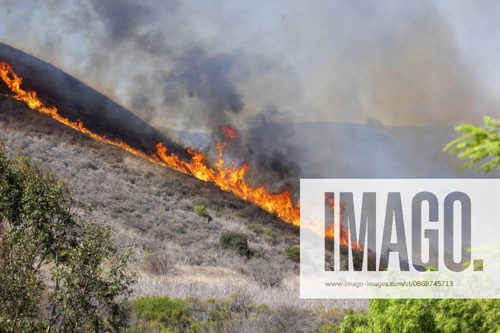 October16, 2026, San Juan Capistrano, California, USA: Fire crews are aggressively battling a wind-driven brush fire that burned several homes and threatened thousands of others in the area of San Juan Capistrano and San Clemente Friday, prompting evacuation orders. The Norte Fire exploded to 465 acres and remains 0 percent contained as of 4 p.m. O.C. Fire Authority officials said the Norte Fire started around 11:30 a.m. near Portico Del Norte and Eminencia Del Norte in San Clemente, east of Interstate 5. Fueled by strong Santa Ana winds, the wildfire then blew into neighboring San Juan Capistrano. San Juan Capistrano USA - ZUMAr19_ 20261016_new_r19_170