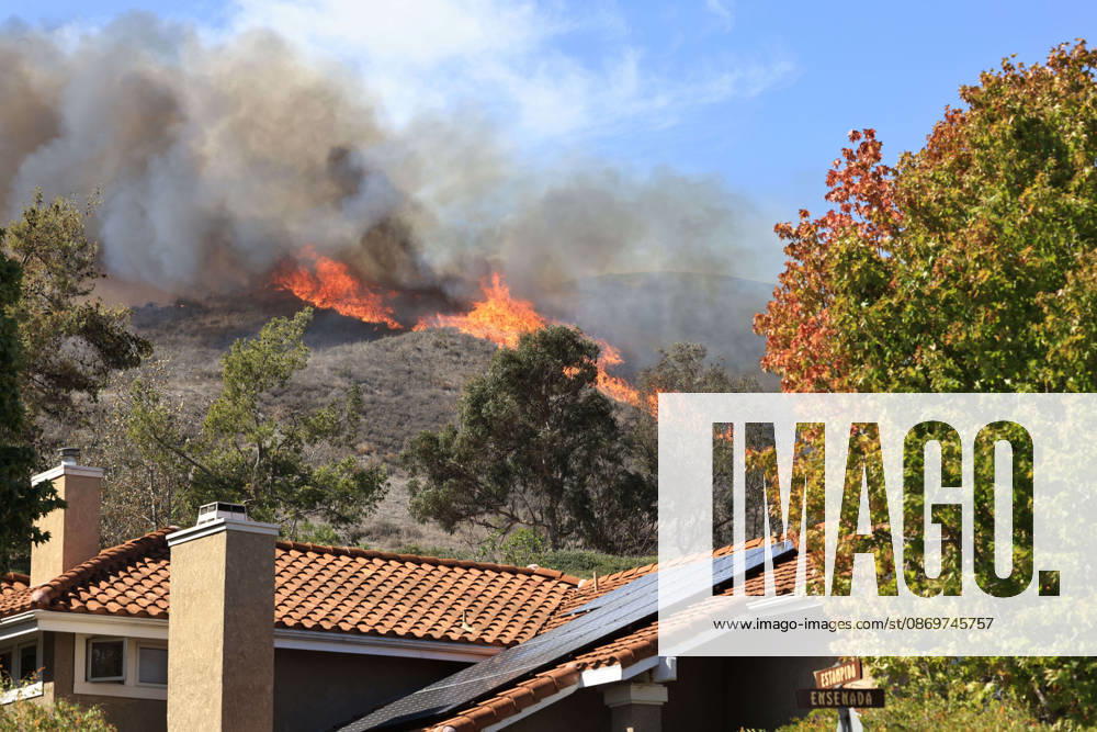 October16, 2026, San Juan Capistrano, California, USA: Fire crews are aggressively battling a wind-driven brush fire that burned several homes and threatened thousands of others in the area of San Juan Capistrano and San Clemente Friday, prompting evacuation orders. The Norte Fire exploded to 465 acres and remains 0 percent contained as of 4 p.m. O.C. Fire Authority officials said the Norte Fire started around 11:30 a.m. near Portico Del Norte and Eminencia Del Norte in San Clemente, east of Interstate 5. Fueled by strong Santa Ana winds, the wildfire then blew into neighboring San Juan Capistrano. San Juan Capistrano USA - ZUMAr19_ 20261016_new_r19_175