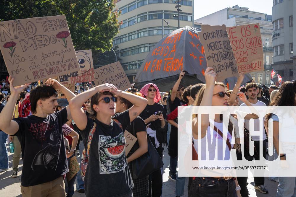 Protesters hold placards with political messages during a housing rights demonstration. Thousands of people joined the National General Confederation of the Portuguese Workers – National Inter-Union (Confederação Geral dos Trabalhadores Portugueses – Intersindical Nacional) (CGTP) demonstration in Porto, marching from Praça da Batalha to Praça de D. João I, where they converged with participants of a housing rights protest. Porto Portugal - ZUMAs197 20261017_aaa_s197_283