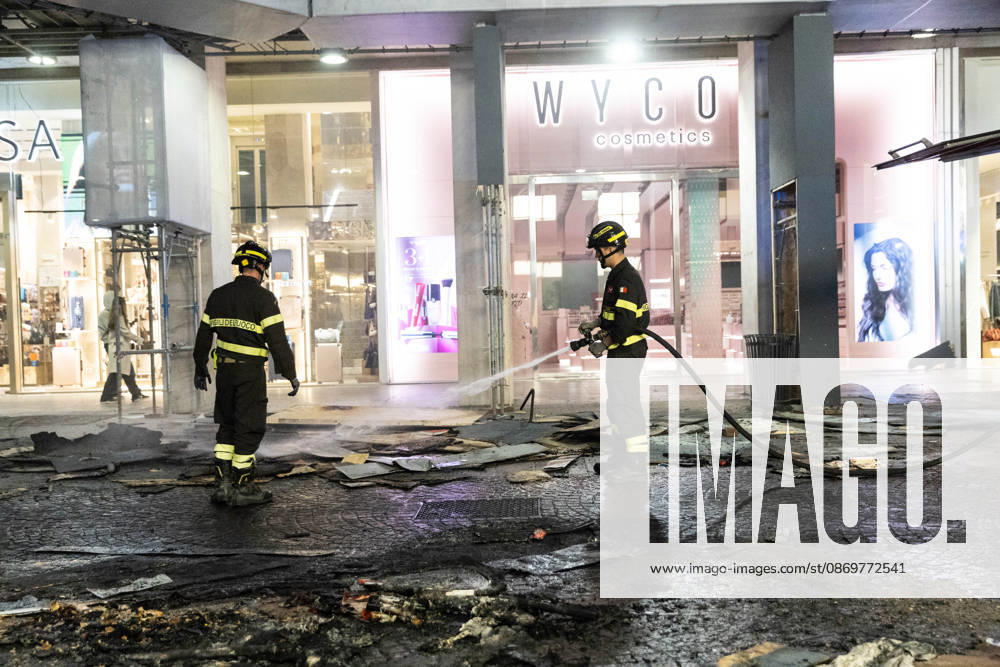 IPA89820374 - Milan, October 17, 2026, Corso Vittorio Emanuele: Damage to storefronts and fires following clashes at the protest against the high cost of living; firefighters