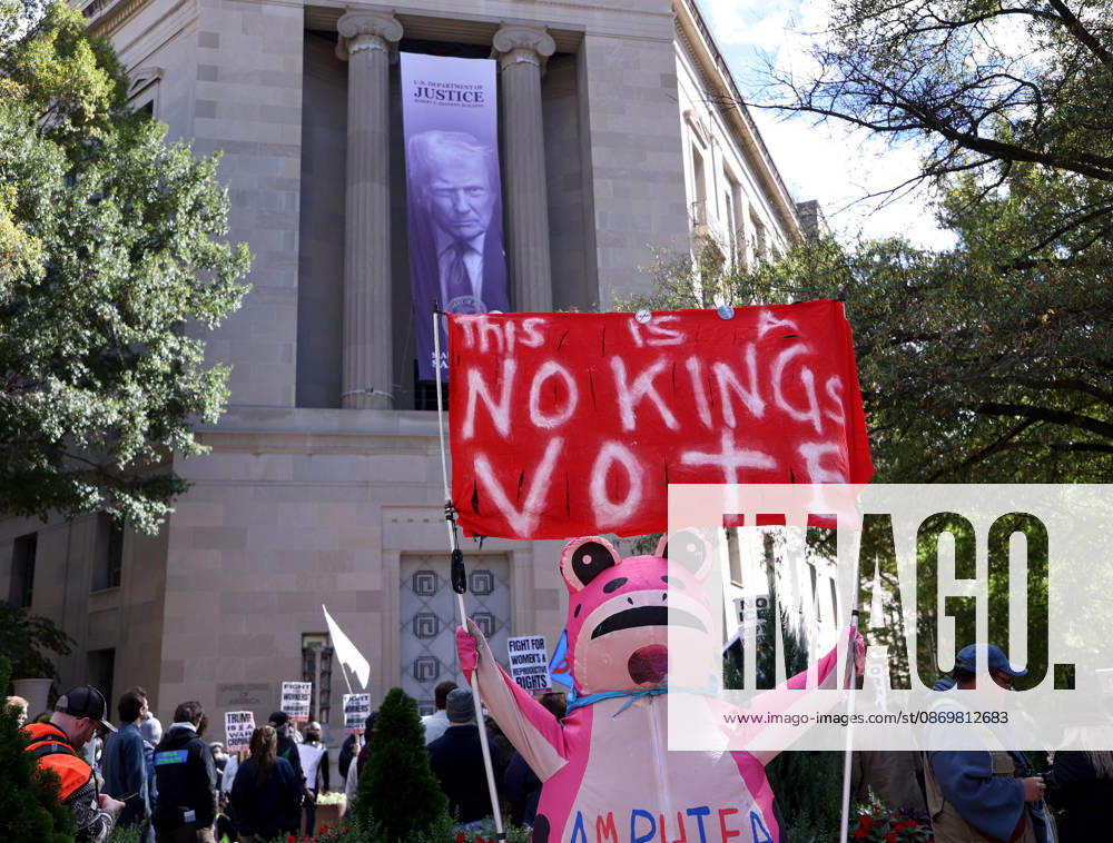 Demonstrators hold banners as they rally in front of the Department of Justice (DOJ) during a No Kings protest in Washington DC, USA on October 17, 2026. Washington USA - ZUMAs337 20261017_znp_s337_040