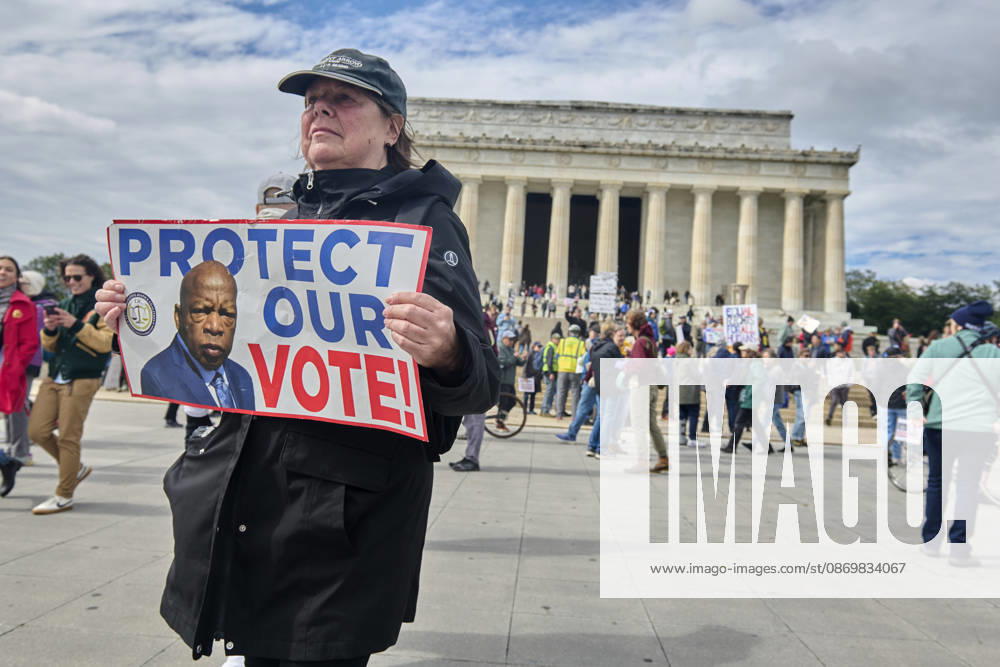 A No Kings holds a sign of late civil rights activist and US Rep. John Lewis during rally at the steps of the Lincoln Memorial in Washington DC, Oct. 17, 2026. The march, intended to encourage people to vote in the 2026 US midterm elections, was part of a 50-state get out the vote operation by the left-leaning Indivisible group. Protesters denounced the administration of US President Donald Trump and the Republican-led Congress for violating Constitutional and civil rights, federal and state laws, judicial orders and longstanding norms, casting Trump and the GOP as a threat to democracy. Washington Dc USA - ZUMAg216 20261017_znp_g216_018