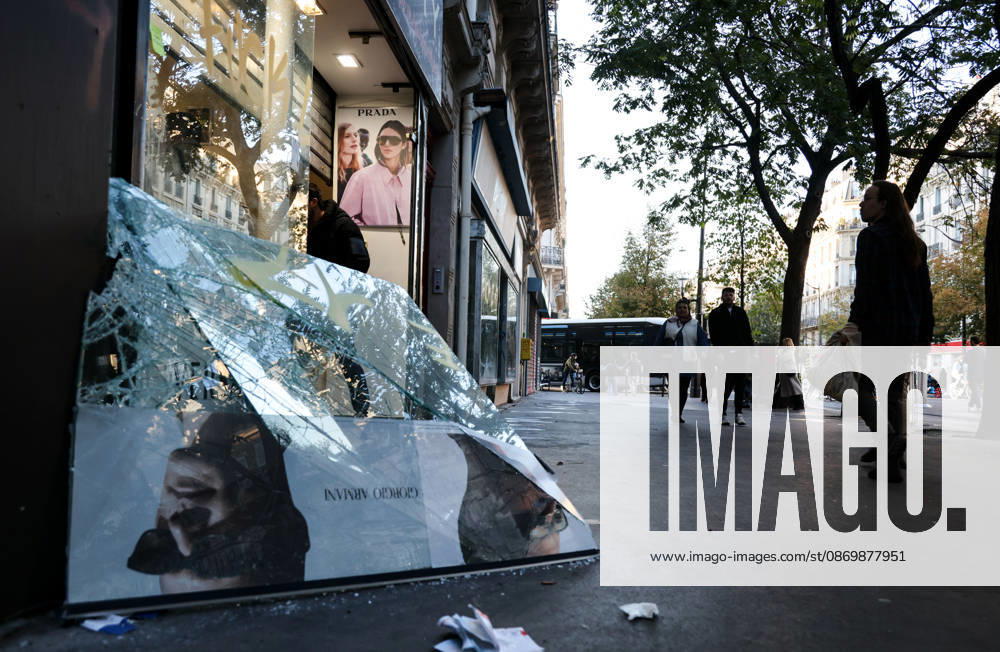(261018) -- PARIS, Oct. 18, 2026 -- People walk past a shop damaged during a protest in Paris, France, Oct. 18, 2026. French President Emmanuel Macron on Sunday vowed legal action against those responsible for violence during protests across the country on Saturday. ) FRANCE-PARIS-PROTEST-VIOLENCE WuxHuiwo