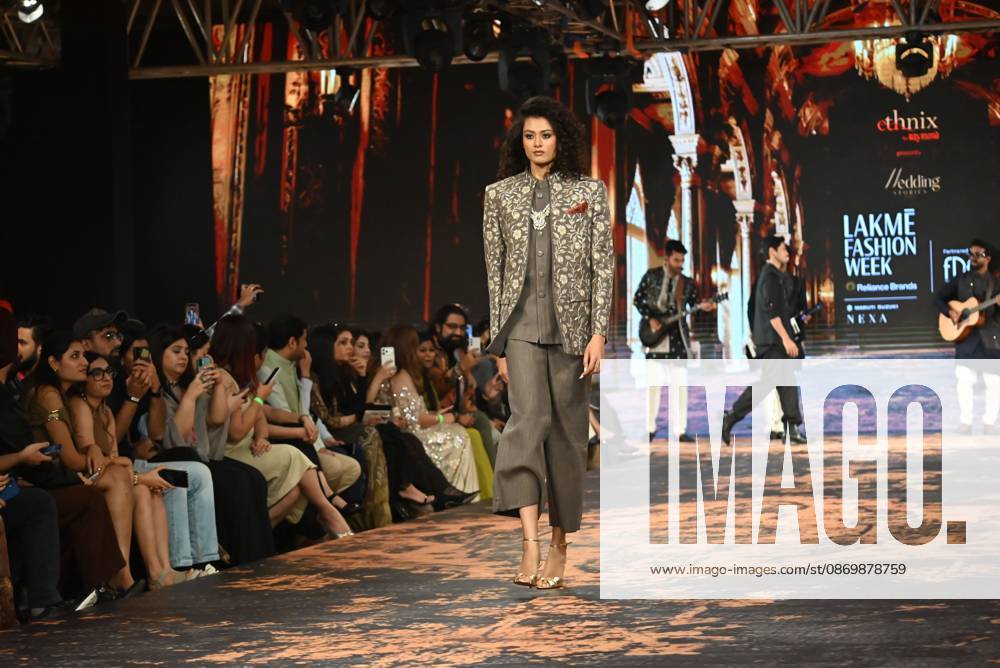 Indian cricketer Suryakumar Yadav presents a creation by Raymond Wedding Stories, alongside models showcasing the collection, during FDCI Lakmo Fashion Week 2026 in New Delhi on Sunday, October 18, 2026. Delhi India - ZUMAq101 20261018_zna_q101_200
