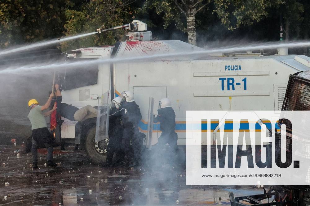 TIRANA, ALBANIA, OCTOBER 18, 2026: Demonstrators clash with riot police in Skanderbeg Square as student-led anti-government protests continue for a sixth consecutive day. Confrontations spread from the Ministry of Education to central Tirana, with protesters throwing stones and pyrotechnics while police deploy tear gas and water cannons. Demonstrators demand improved university conditions and the resignation of Prime Minister Edi Rama. Tirana Albania - ZUMAq101 20261018_zna_q101_228