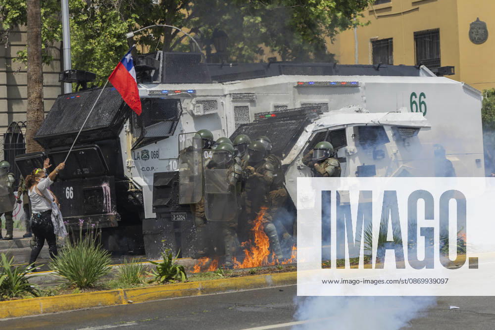A Molotov cocktail bomb falls on the feet of special forces police officers. In the center of the capital of Chile, different incidents took place between demonstrators and the police. The riots were carried out during the commemoration of the 7 years after the social outcast that happened on October 18, 2019. Santiago Chile - ZUMAs197 20261019_aaa_s197_014