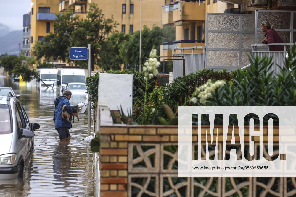 The Valencian Regional Government is preparing a lockdown order for the southern coast of Valencia and the northern coast of Alicante due to the rains. A man walks through a flooded area with a dog on October 19, 2026, in Guardamar de la Safor, Valencia, Valencian Community, Spain. The Valencian Regional Government is preparing a lockdown order for the southern coast of Valencia and the northern coast of Alicante in response to the emergency declared due to the rains brought by Storm Adam, as announced by the Regional Minister of Emergencies and the Interior early this morning, October 19, from the Emergency Coordination Center (CCE) October 19, 2026, Valencia, Valencian Community, Spain