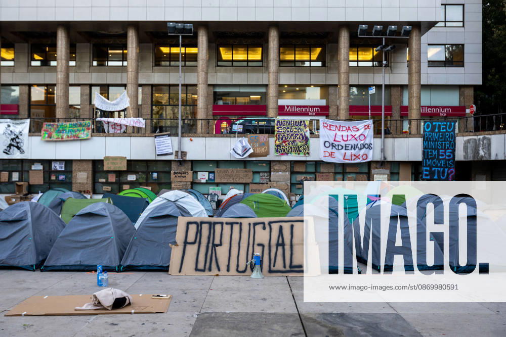 A banner saying Portugal stands among tents at the housing protest camp in Praca D. Joao I. Activists remained in the square for another night while awaiting a possible police intervention to remove the encampment as the authorized protest approached its final days. Porto Portugal - ZUMAs197 20261019_aaa_s197_101