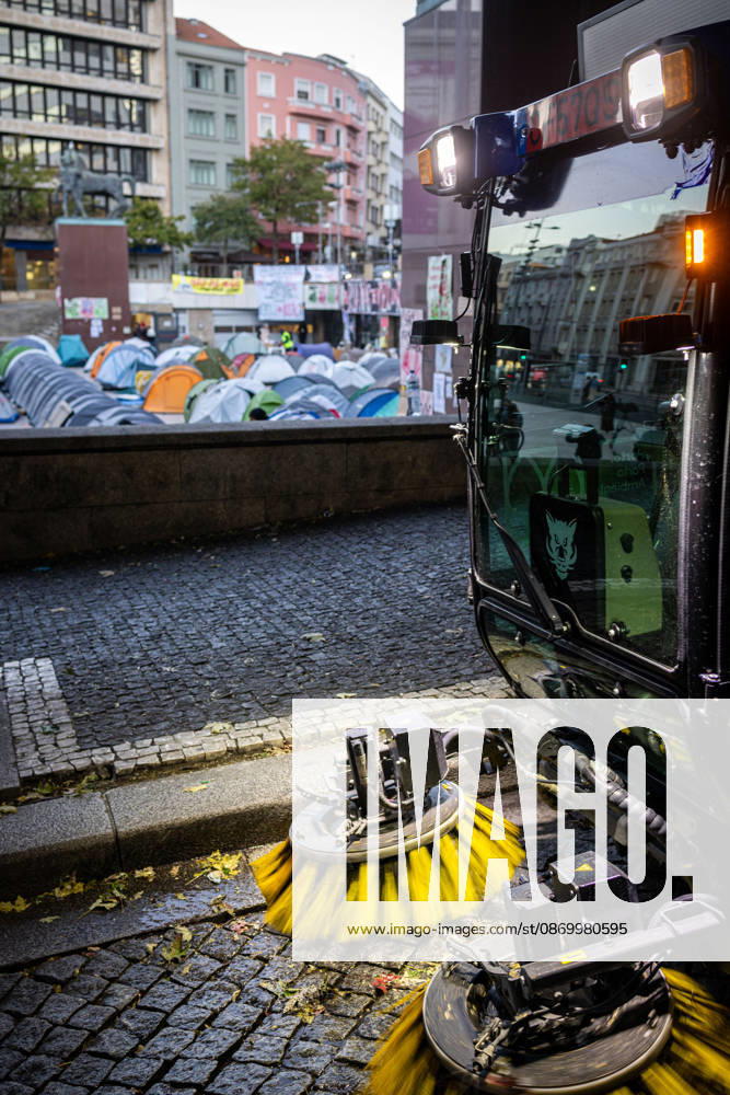 A street-cleaning vehicle operates beside the housing protest camp at Praca D. Joao I. Activists remained in the square for another night while awaiting a possible police intervention to remove the encampment as the authorized protest approached its final days. Porto Portugal - ZUMAs197 20261019_aaa_s197_102