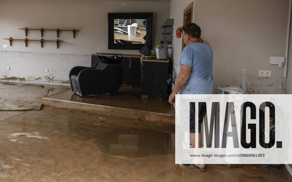 The Valencian Regional Government is preparing a lockdown order for the southern coast of Valencia and the northern coast of Alicante due to the rains. A person leans against the wall of their home, which has been damaged by flooding caused by heavy rains, on October 19, 2026, in Els Poblets, Valencian Community, Spain. The Valencian Regional Government is preparing a lockdown order for the southern coast of Valencia and the northern coast of Alicante in response to the emergency declared due to the rains brought by Storm Adam, as announced by the Regional Minister of Emergencies and the Interior early this morning, October 19, from the Emergency Coordination Center (CCE) October 19, 2026, Valencia, Valencian Community, Spain