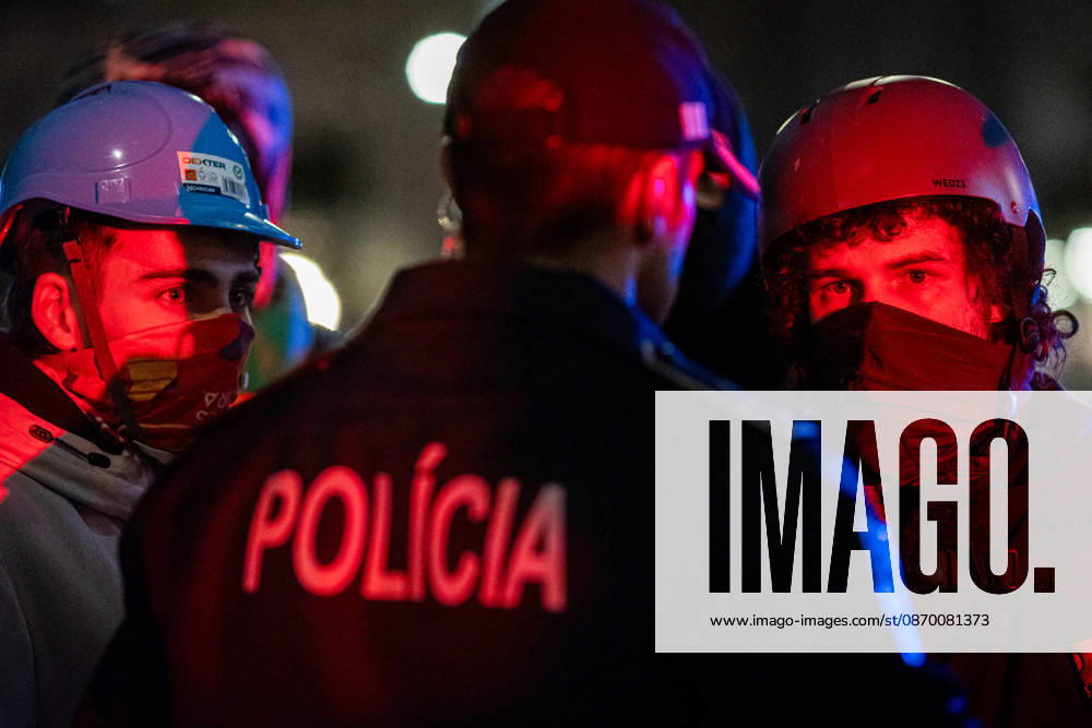 Police officers and protesters stand face-to-face during the operation to clear the housing protest camp at Praca D. Joao I. Participants formed human chains while dismantling the encampment. Porto Portugal - ZUMAs197 20261020_aaa_s197_045