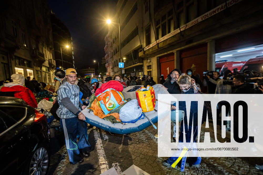 Protesters seen carrying the remaining camp materials through the streets surrounding Praca D. Joao I after the dismantling of the housing protest camp. Porto Portugal - ZUMAs197 20261020_aaa_s197_058