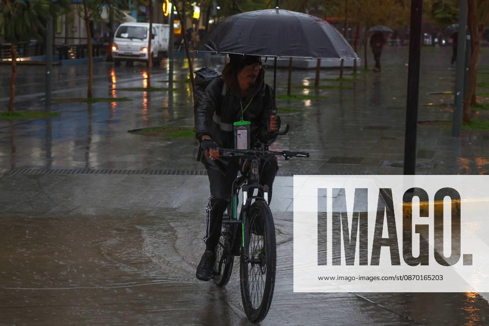 Heavy rainfall triggers red alert and emergency evacuations in Chile SANTIAGO, CHILE – OCTOBER 20: A food delivery worker shields himself with an umbrella in Santiago, Chile, on October 20, 2026. On Tuesday, Chile declared a red alert for the Metropolitan Region due to heavy rainfall, marking the rainiest October in Santiago in over a century. Lucas Aguayo Araos Anadolu Talagante Chile. Editorial use only. Please get in touch for any other usage.