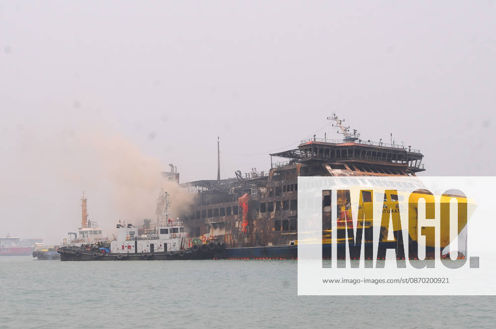 Efforts are underway to extinguish a fire that broke out on a passenger ferry in Indonesia s Cilegon PELABUHAN MERAK, CILEGON, INDONESIA - OCTOBER 21: Fireboats take turns spraying water onto the passenger ferry KMP Batumandi to cool down the vessel after it caught fire while preparing to dock off Merak Port in Cilegon, Banten, Indonesia on Wednesday, October 21, 2026. The vessel caught fire on Tuesday, October 20, and rescue operations remain underway as the ship continues to emit smoke. Water is continuously sprayed to cool the vehicle deck containing numerous cars, motorcycles, buses, and trucks, while authorities confirm no fatalities have been reported. Dasril Roszandi Anadolu Pelabuhan Merak Indonesia. Editorial use only. Please get