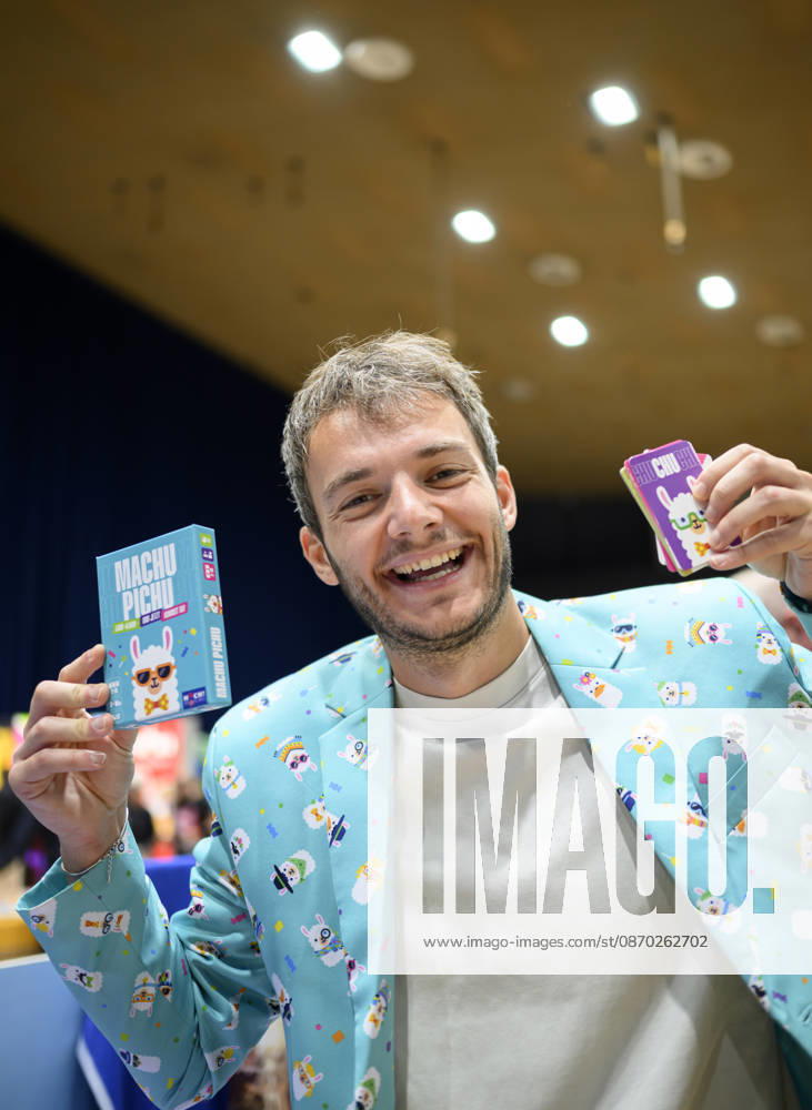 An employee in a llama costume demonstrates the party game Machu Pichu, playing cards, cards, and new product showcase on October 21, 2026, at the SPIEL Essen trade show, held from October 22–25, 2026, in Essen, Germany, at the Grugahalle.