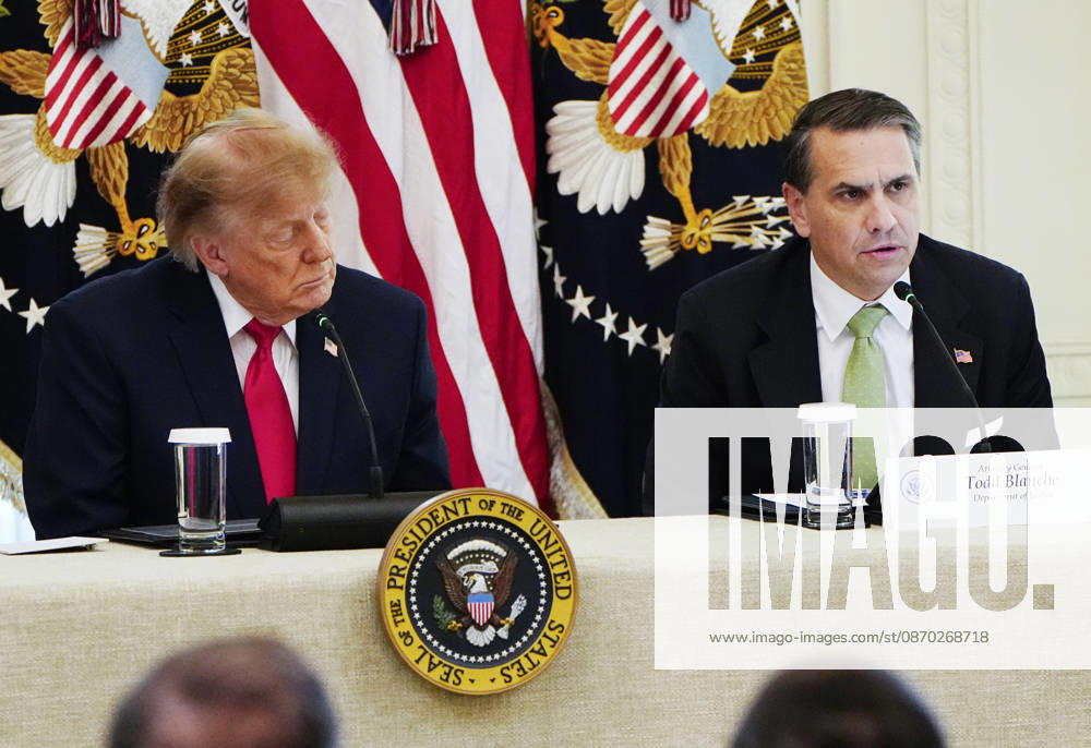 President Donald Trump (L) and Attorney General Todd Blanche attend a roundtable discussion on cybercrime in the East Room of the White House in Washington, DC on Wednesday, October 21, 2026. The discussion focuses on combatting foreign-based organized crime targeting Americans online and federal seizures of fraudulent crypto and scam websites. WAP20261021907 BONNIExCASH