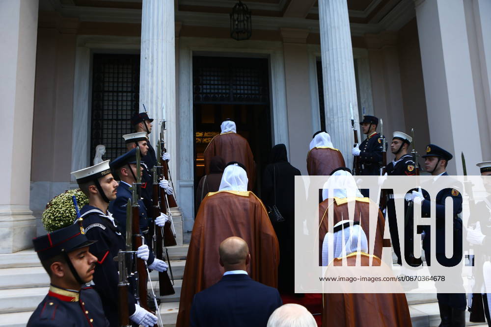 Members of the delegation accompanying Abu Dhabi Crown Prince Sheikh Khaled bin Mohamed bin Zayed Al Nahyan, including a woman dressed in black, ascend the steps of the Maximos Mansion in Athens ahead of an official meeting with Greek Prime Minister Kyriakos Mitsotakis. A military honour guard stands at attention on either side of the entrance as the Emirati delegation enters the Greek prime ministers official residence. Athens Greece - ZUMAv62_ 20261022_zaf_v62_017