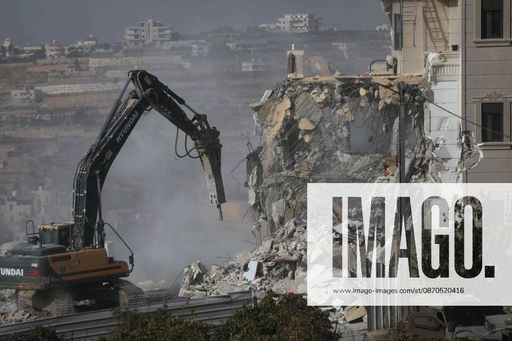 Israeli forces demolish a building in West Bank city of Hebron HEBRON, WEST BANK, PALESTINE - OCTOBER 23: Israeli military heavy machinery demolishes a building during a raid in the West Bank city of Hebron, Palestine, on October 23, 2026. The Israeli military announced earlier in the morning that two of its soldiers were killed during armed clashes with Palestinians, triggering a large-scale military operation and structural demolition in the city. Mamoun Wazwaz Anadolu Hebron West Bank. Editorial use only. Please get in touch for any other usage.