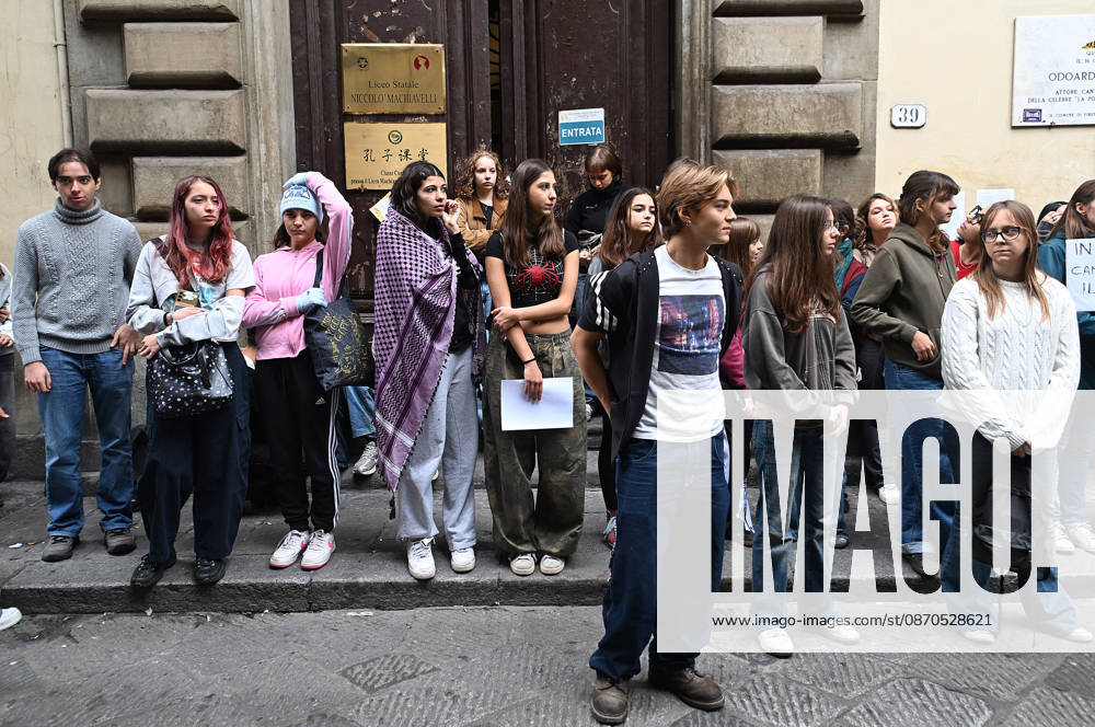 In front of the Machiavelli High School on Via Santo Spirito, a group of teachers held an open lesson on the street with megaphones and signs, addressing students leaning out of their windows and standing in front of the occupied school s door. Florence, October 23, 2026 Florence Italy - ZUMAa289 20261023_zia_a289_120