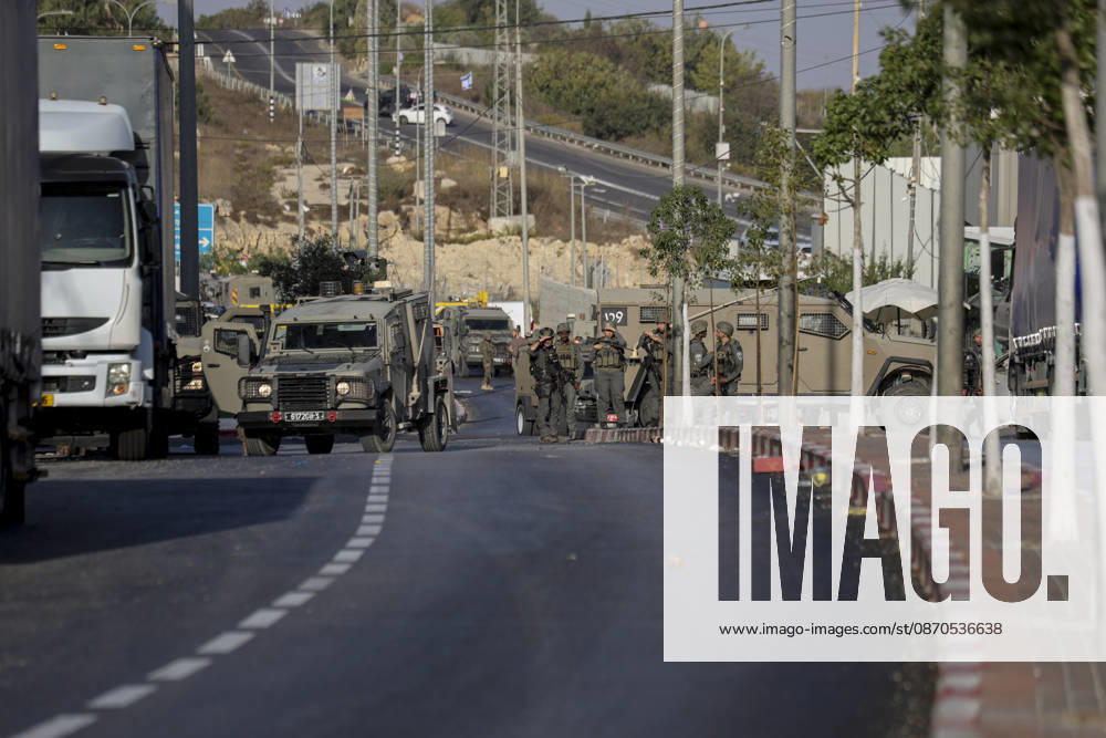 Hebron West Bank Shooting Attack Israeli military vehicles stand guard at the entrance to Farsh al-Hawa near Hebron, in the occupied West Bank on October 23, 2026. Journalists were targeted and the area was declared a closed military zone following a Palestinian shooting attack targeting an Israeli military checkpoint at the entrance to Farsh al-Hawa in Hebron. Hebron West Bank Palestinian Territories