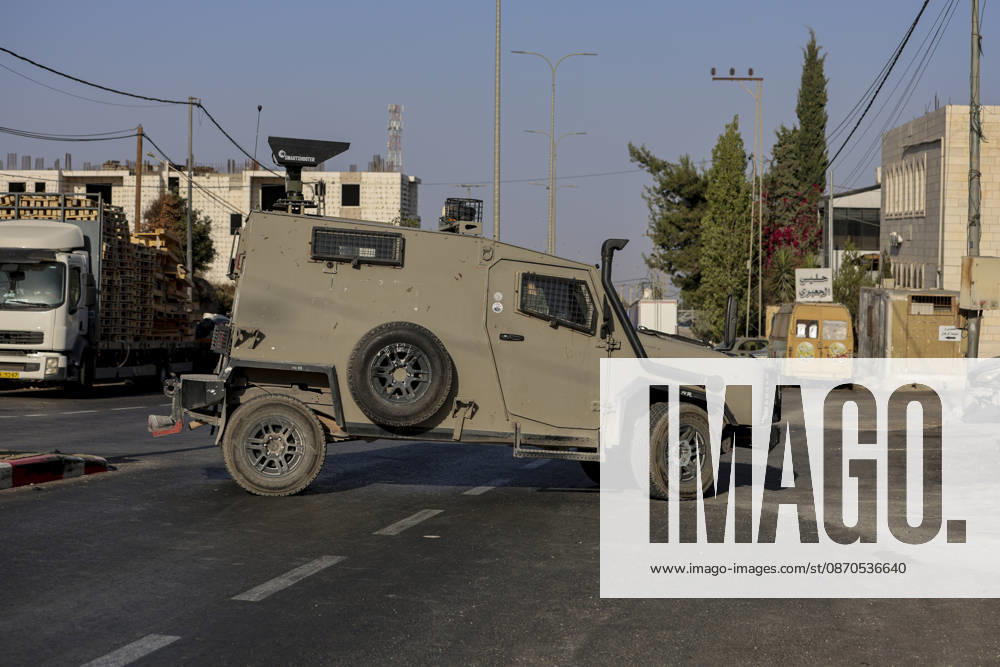 Hebron West Bank Shooting Attack An Israeli military vehicle stands guard at the entrance to Farsh al-Hawa near Hebron, in the occupied West Bank on October 23, 2026. Journalists were targeted and the area was declared a closed military zone following a Palestinian shooting attack targeting an Israeli military checkpoint at the entrance to Farsh al-Hawa in Hebron. Hebron West Bank Palestinian Territories