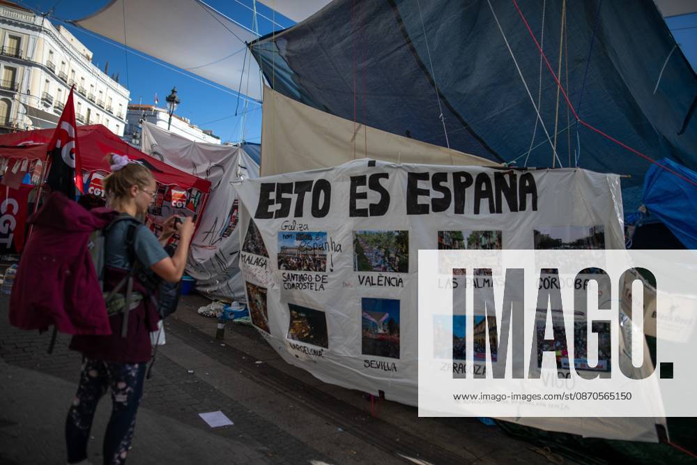 A banner featuring photographs and the phrase This is Spain can be seen at Puerta del Sol..Tents remain set up by housing rights activists, who organized the occupation of the square in response to the eviction of Maricarmenâ€a woman in her eightiesâ€from her home, carried out by a real estate investment fund. Madrid Spain - ZUMAs197 20261023_aaa_s197_153