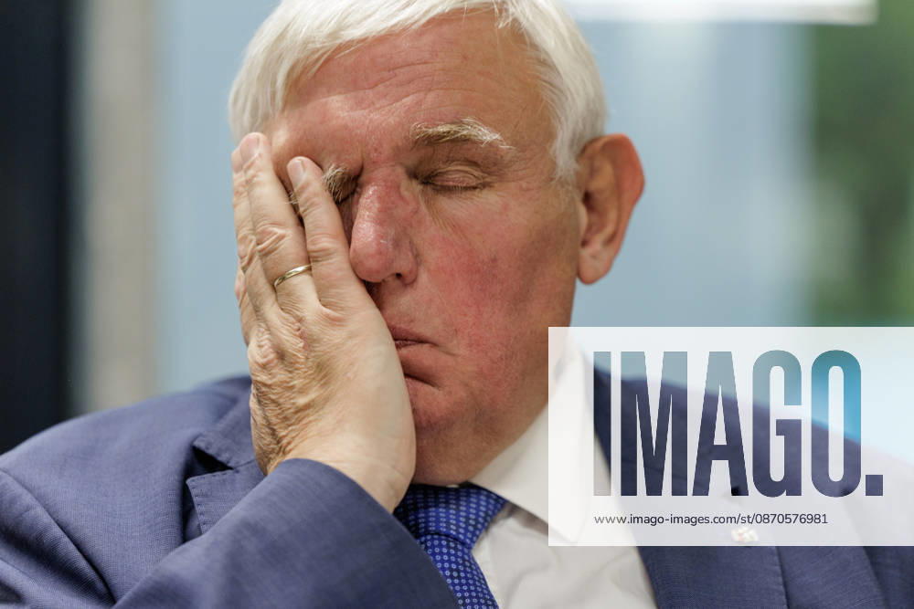 Karl Josef Laumann (CDU), Minister of Labor and Social Affairs for North Rhine-Westphalia, attended a WVS business breakfast on October 23, 2026, at the Caritas Emstor Workshops (WfbM) in Rheine, North Rhine-Westphalia, Germany, runs his hand across his face.