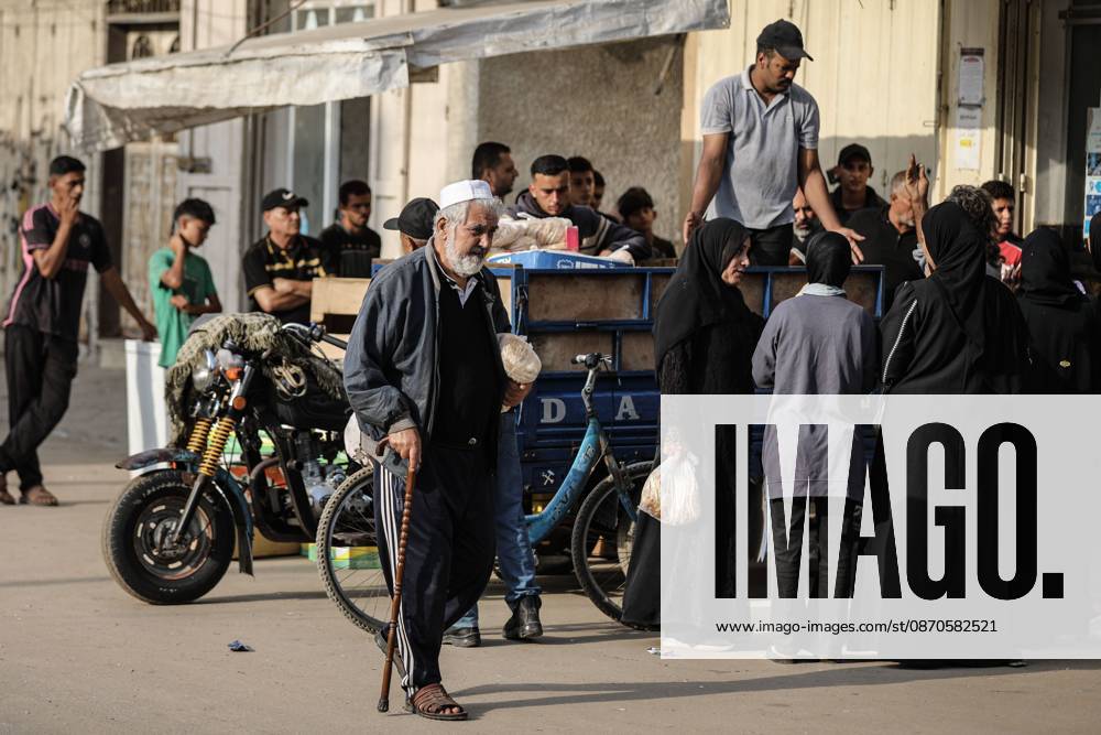 Palestinians Queue For Bread NUSEIRAT, PALESTINE, OCTOBER 24, 2026: Palestinians crowd outside bakeries to obtain bread in Nuseirat refugee camp in the central Gaza Strip amid flour shortages and disruptions to supplies entering the territory. The shortages coincide with funding cuts that have forced the United Nations World Food Programme to reduce food assistance, adding pressure on families struggling to meet their daily needs. Nuseirat Palestine, State of