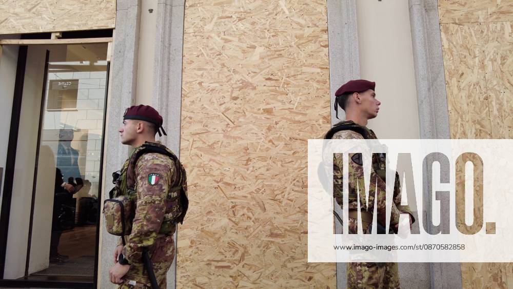 IPA90116645 - Italy, Milan: Luxury stores on Via Montenapoleone with shop windows barricaded against looting, and soldiers from the Folgore Brigade patrolling the streets to keep out looters and violent protesters
